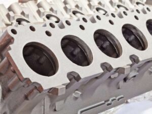 Cylinder head with multiple combustion chambers for engine performance.