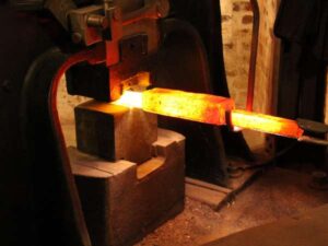 Industrial steel forging for manufacturing and metalworking.